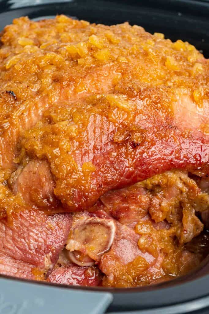 Close up of slow cooker ham with pineapple that is fully cooked.