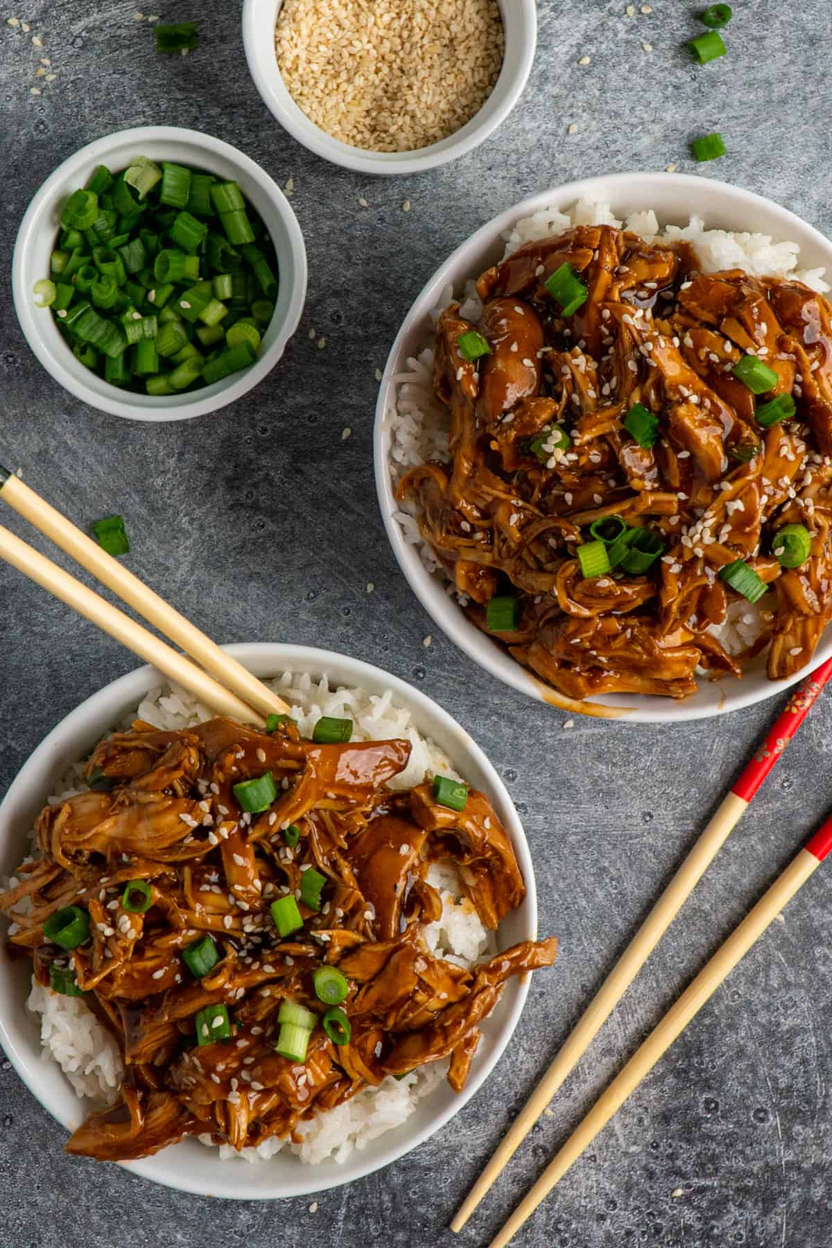 Two bowls of teriyaki chicken over rice.