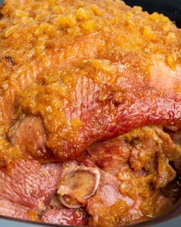 Close up of slow cooker ham with pineapple that is fully cooked.