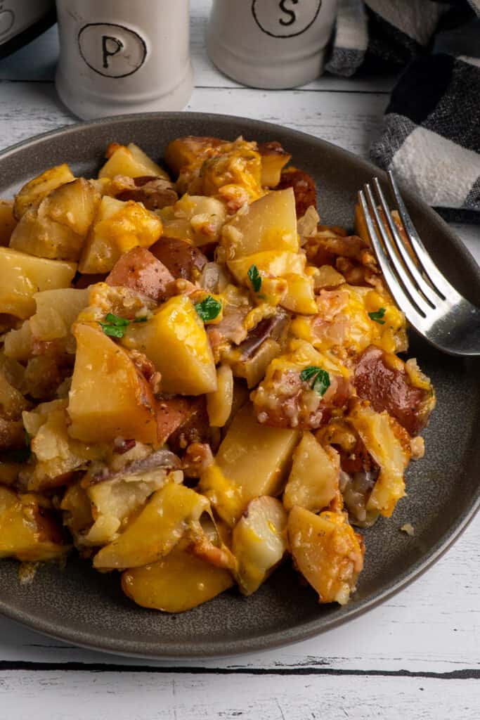 Crock-Pot cheesy bacon ranch potatoes on a grey plate.