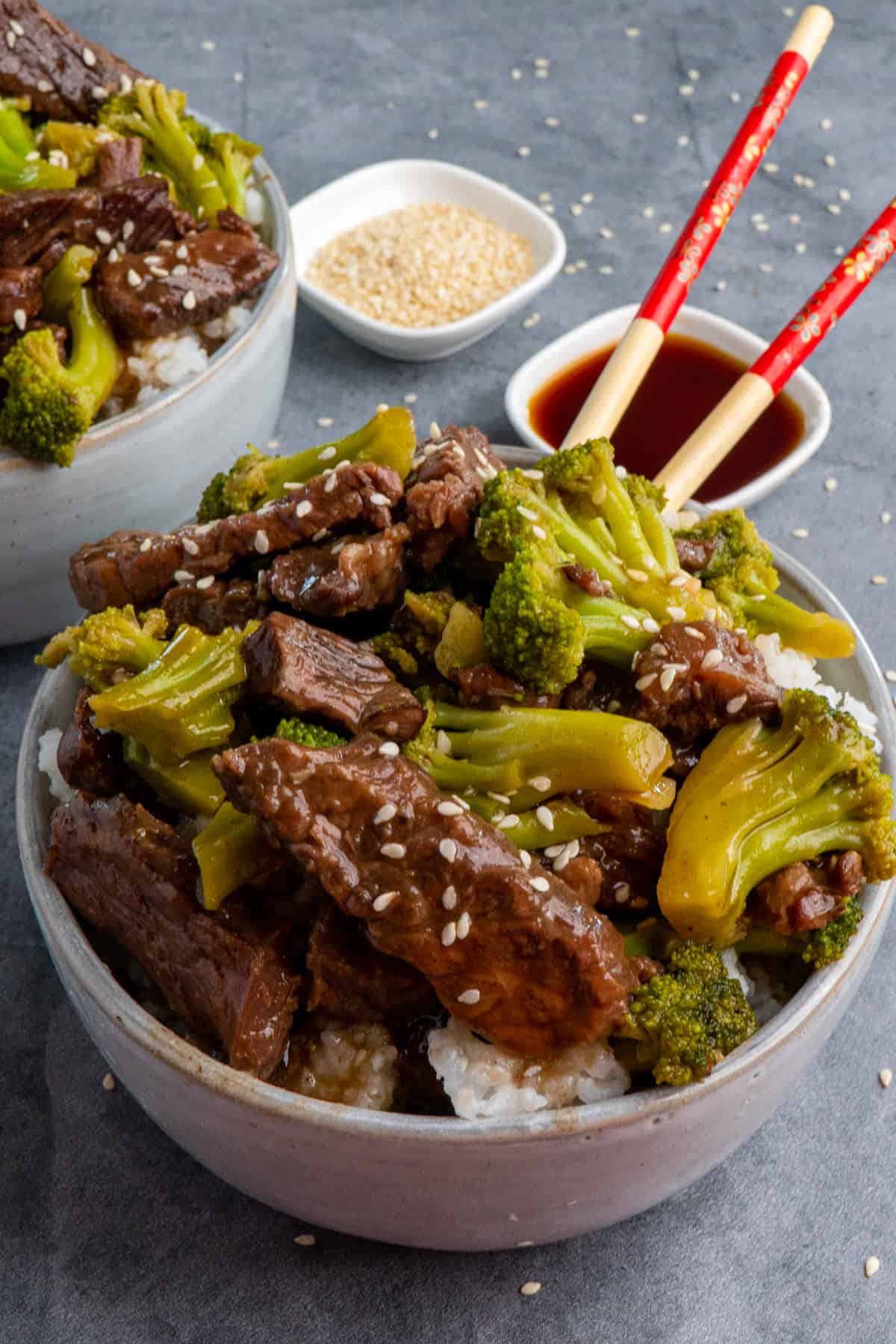 Close up of Crock Pot beef and broccoli in a bowl garnished with sesame seeds.