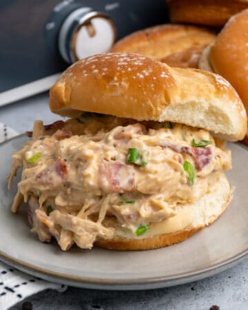 Close up of Crock-Pot crack chicken on a fresh potato bun.