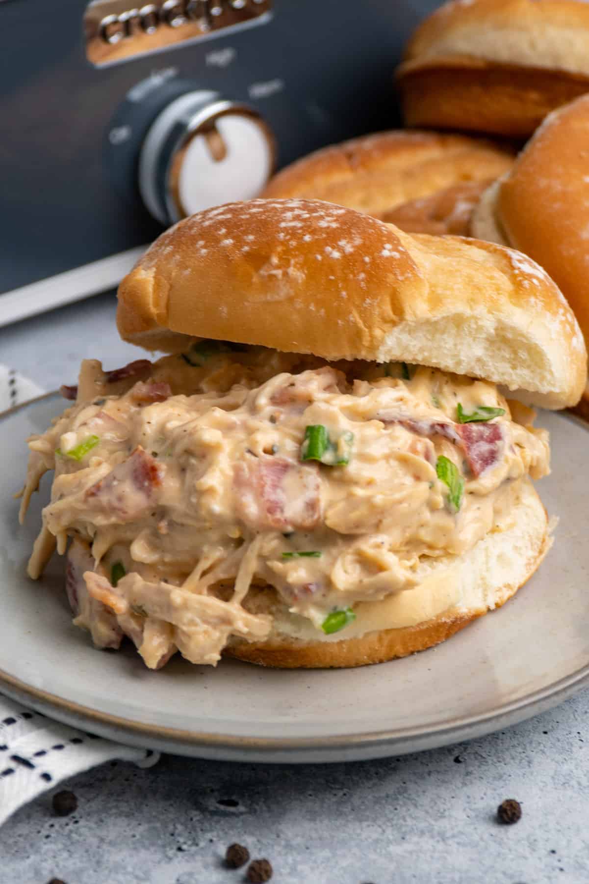 Close up of Crock-Pot crack chicken on a fresh potato bun.