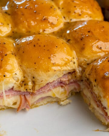 Close up of ham and cheese sliders to show off the melted cheese in a Crock-Pot.