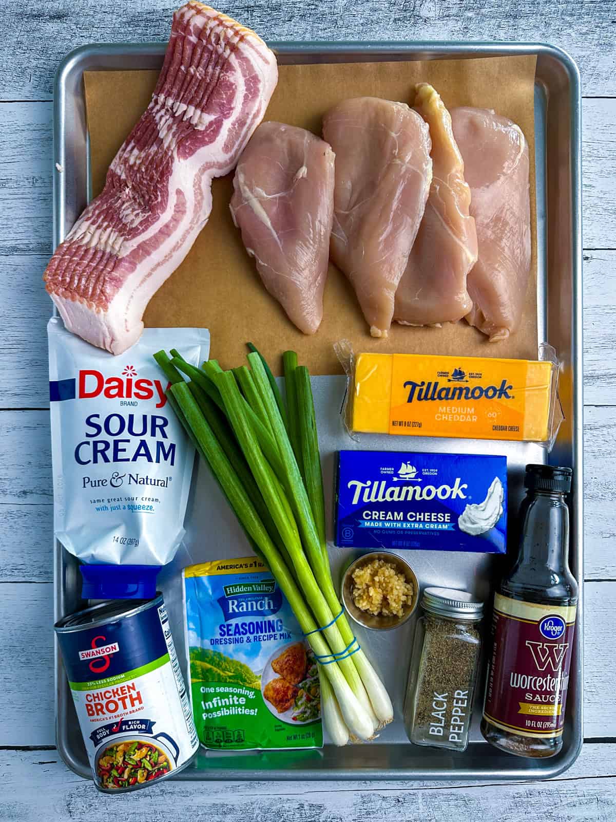 Ingredients for slow cooker crack chicken on a baking sheet.