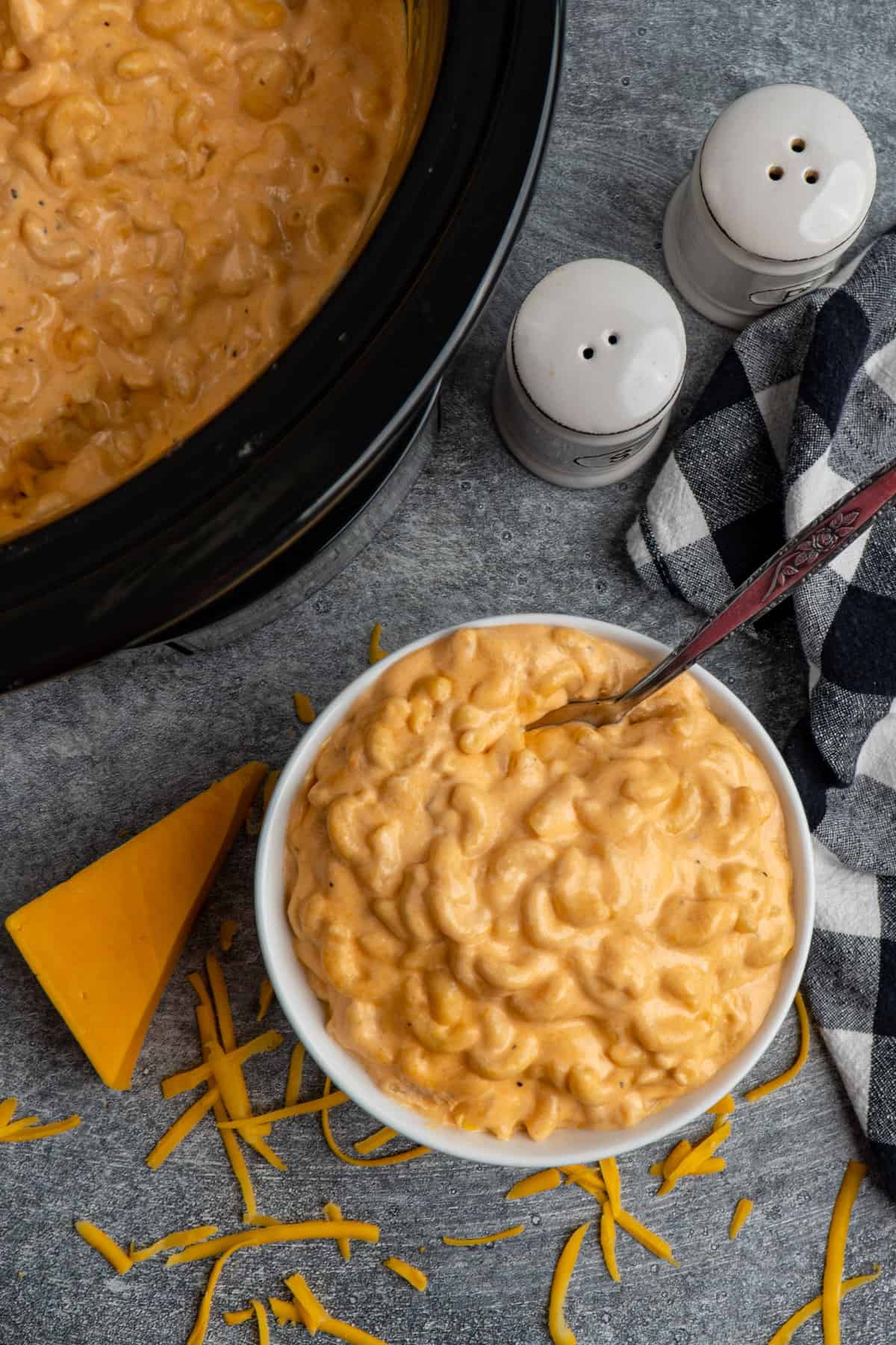 Overhead look at creamy mac and cheese in a bow and a Crock-Pot.