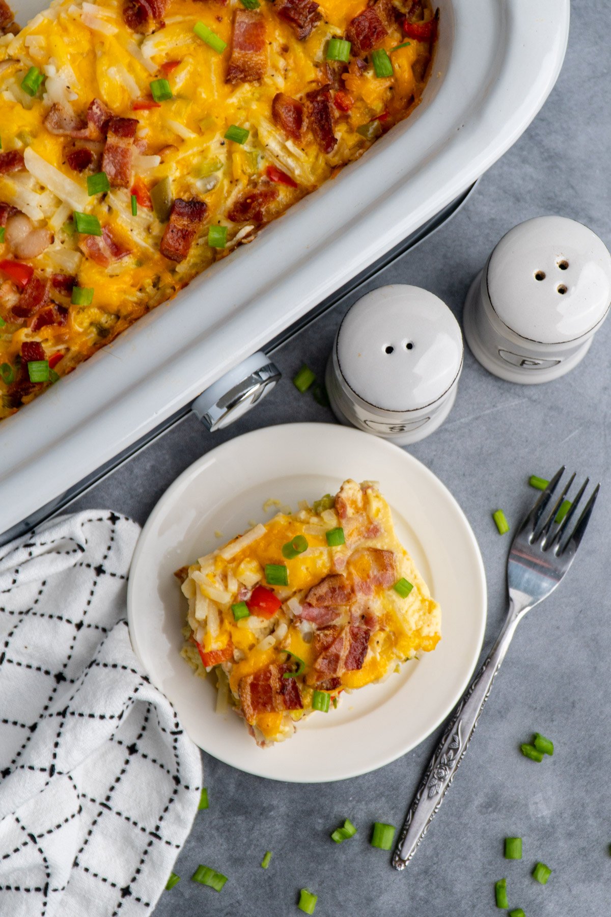 Overhead look at breakfast casserole in a slow cooker and on a white plate.