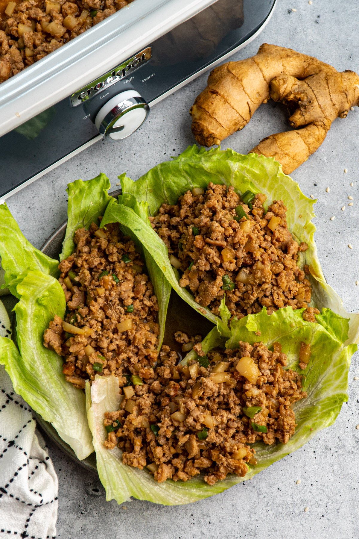 Overhead look at three slow cooker copycat PF Changs Chicken Lettuce Wraps on a plate.