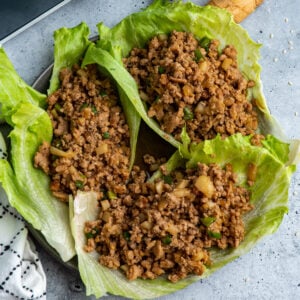 Overhead look at three slow cooker copycat PF Changs Chicken Lettuce Wraps on a plate.