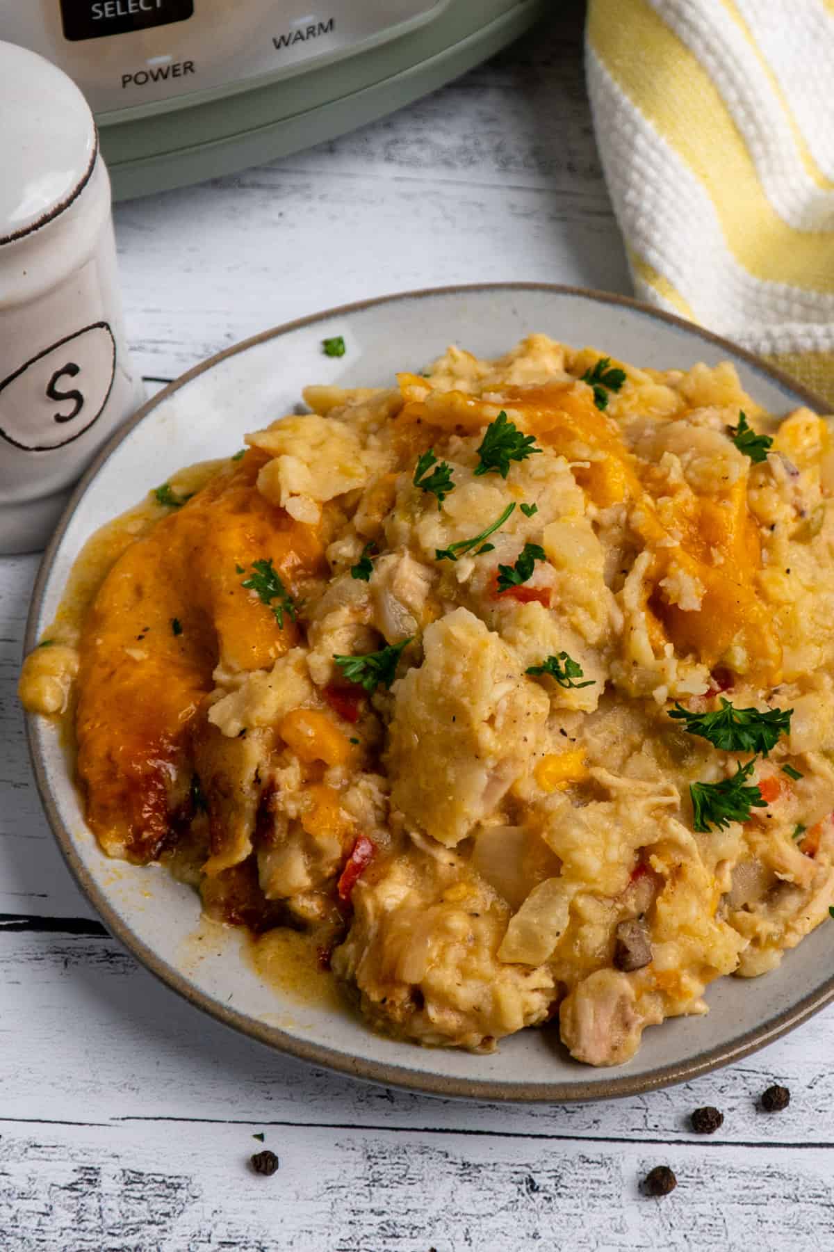 Overhead look at slow cooker king ranch chicken on a gray plate.