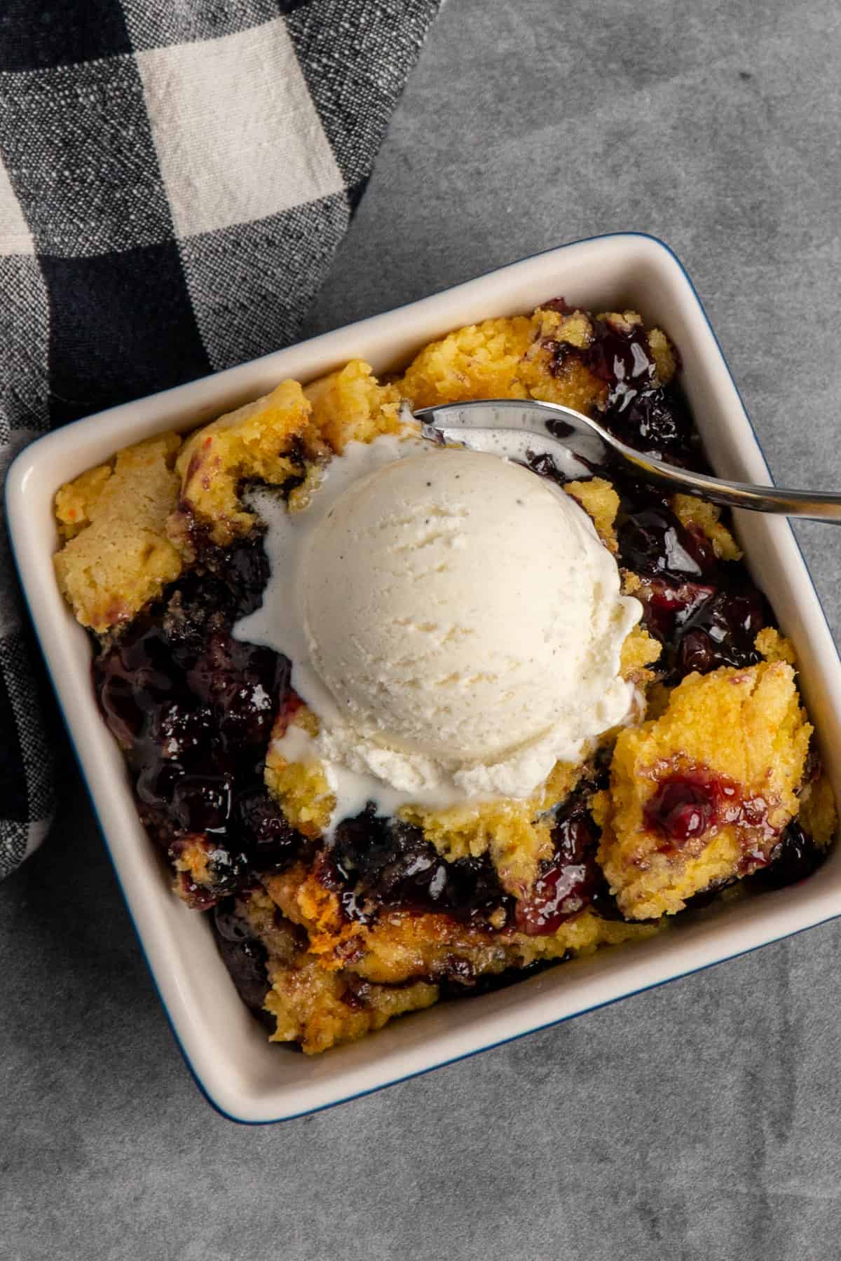 Overhead look at blueberry cobbler with ice cream on top