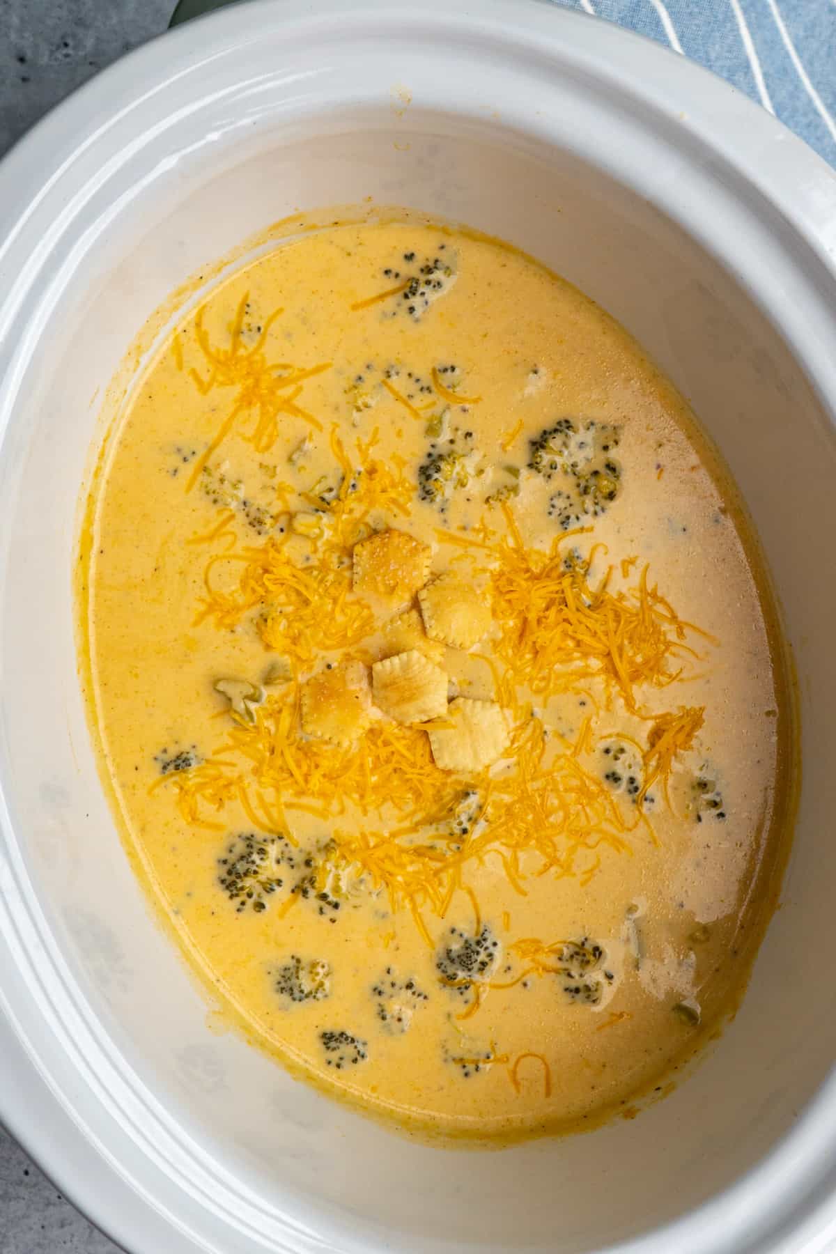 Overhead look at broccoli cheese soup in a white slow cooker