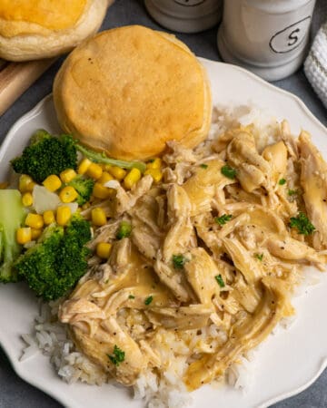 Crock Pot chicken and gravy over rice with a side of veggies.