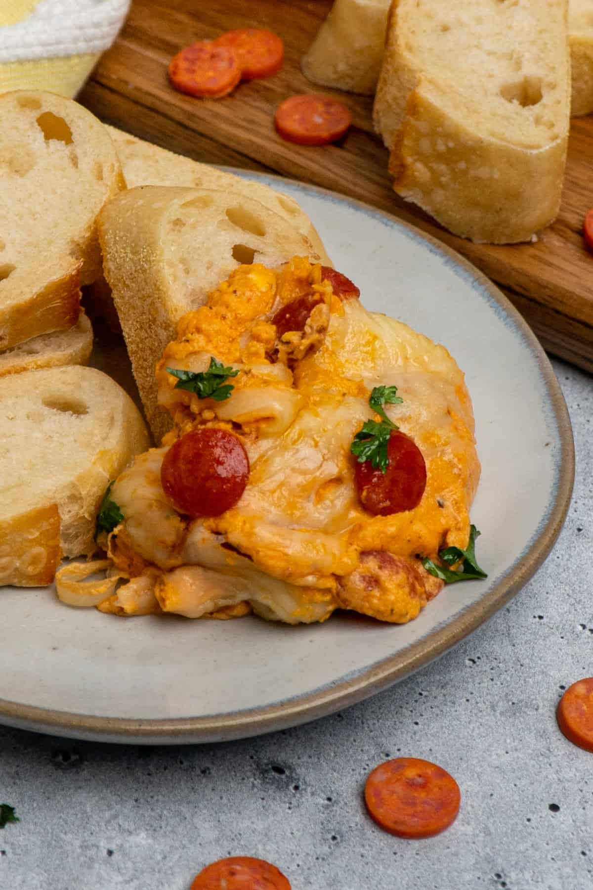 Pizza dip on a plate with bread