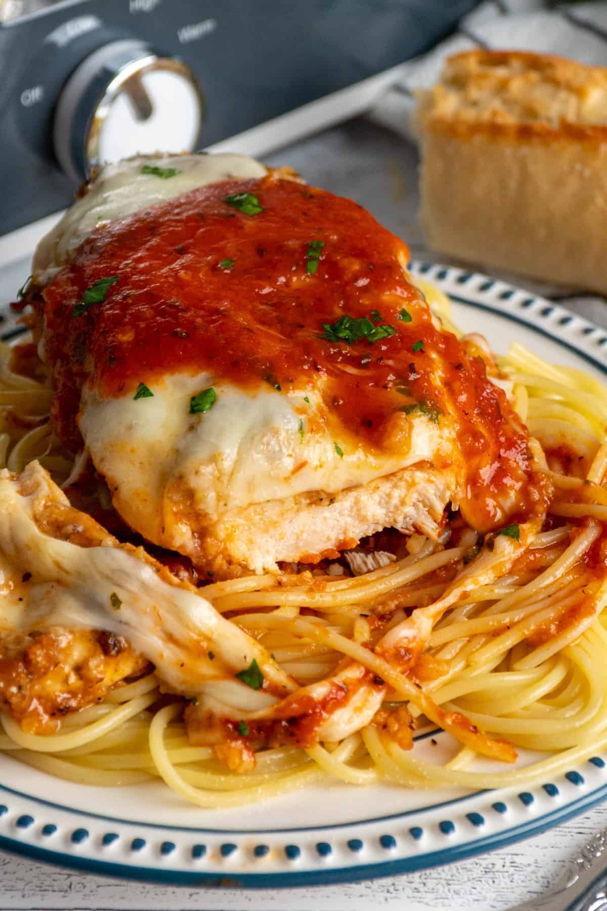 Chicken with mozzarella cheese and pasta sauce on it.