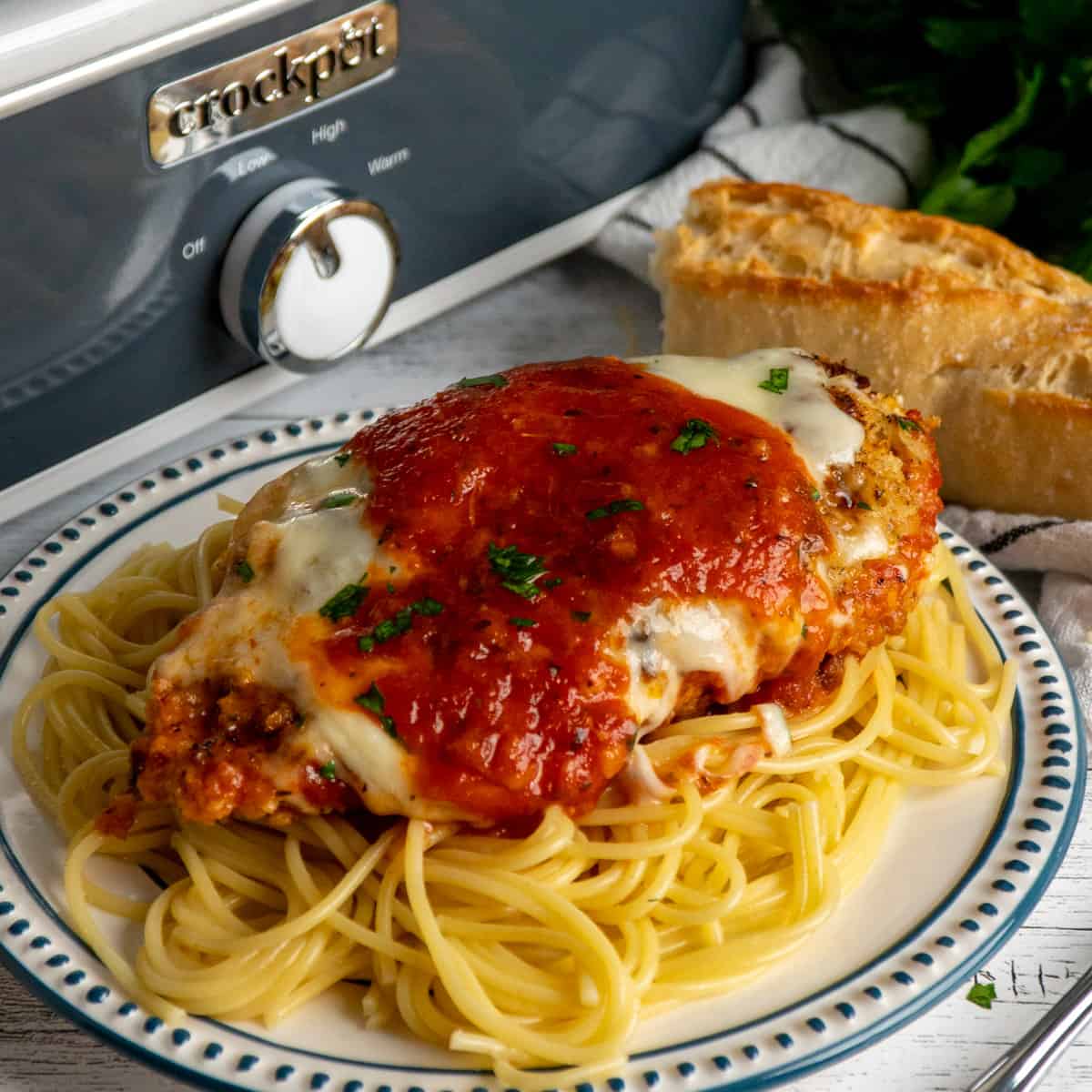 Parmesan chicken over a plate of spaghetti