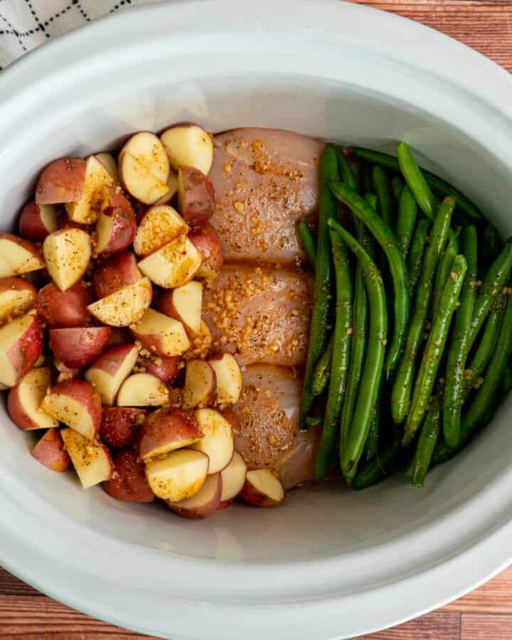 Crockpot Chicken Potatoes and Green Beans with seasoning on them.