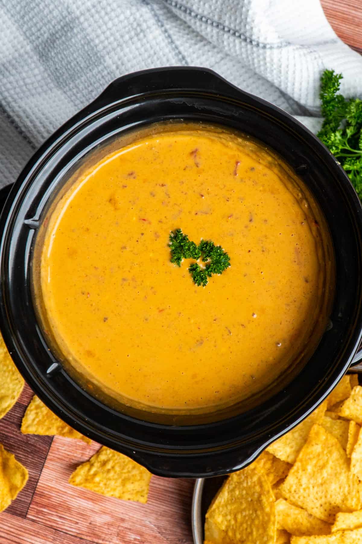 Overhead look at chili cheese dip in a slow cooker.