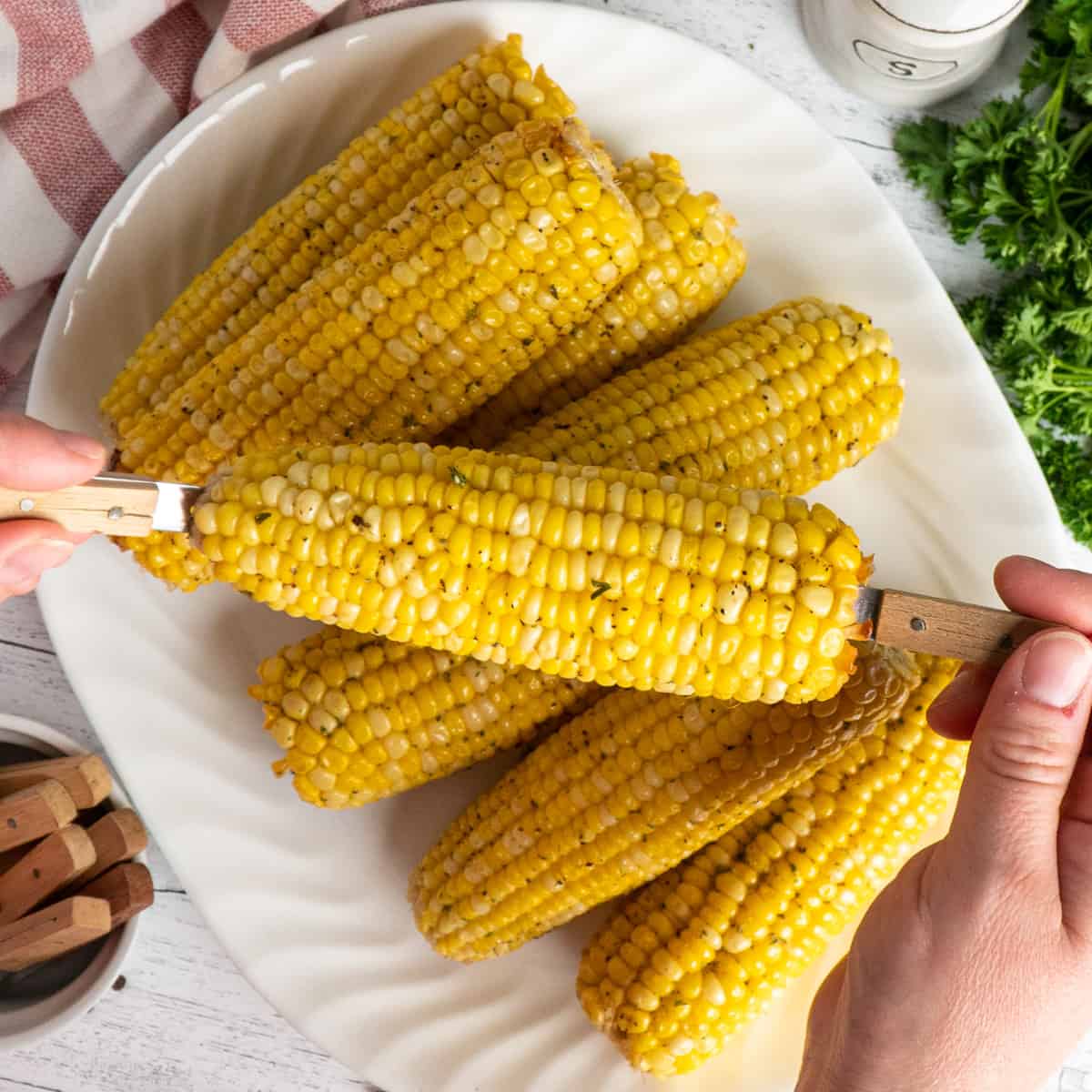 A plate full of crock pot corn on the cob.