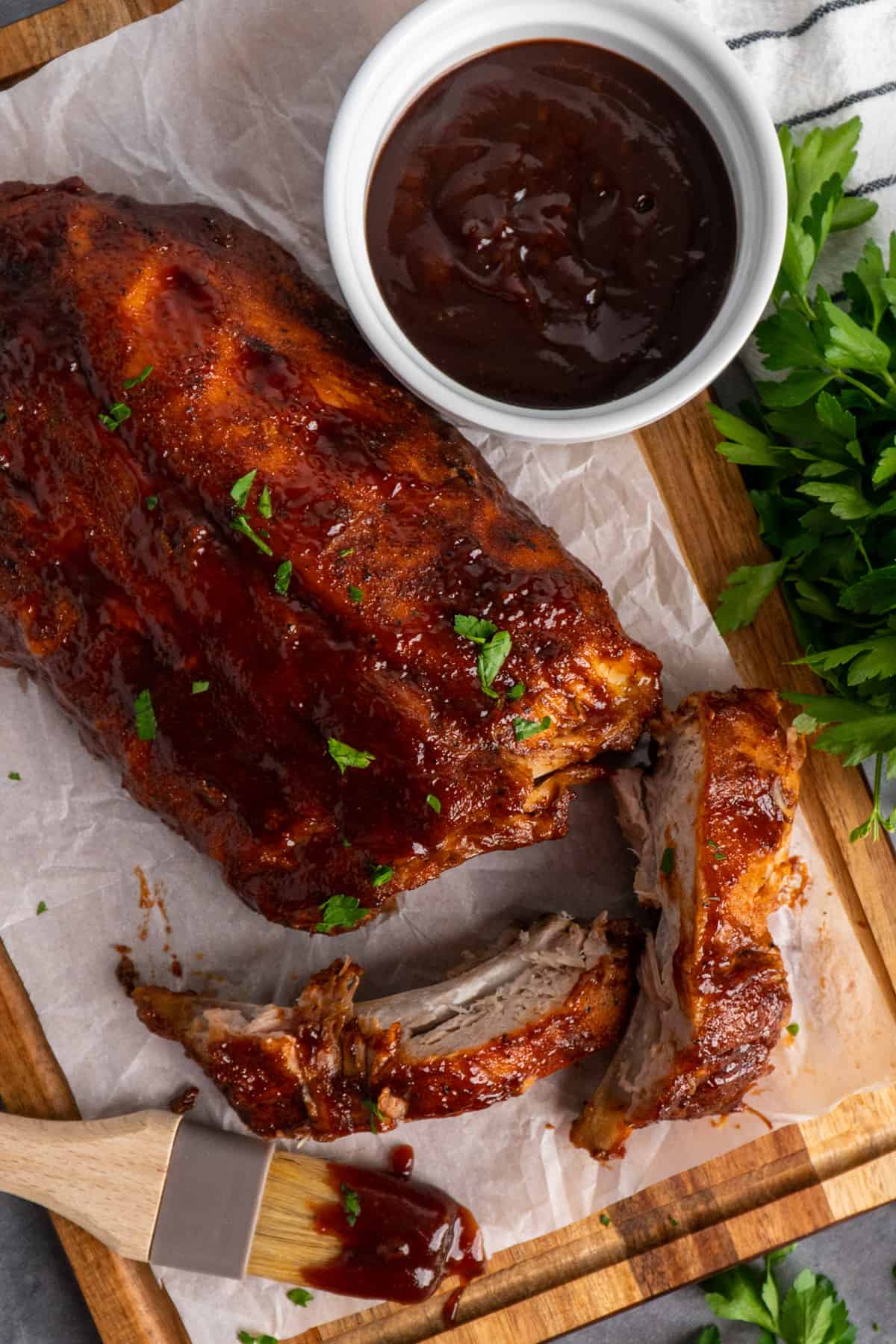 Overhead look at crock pot Dr. Pepper ribs on a wood cutting board.