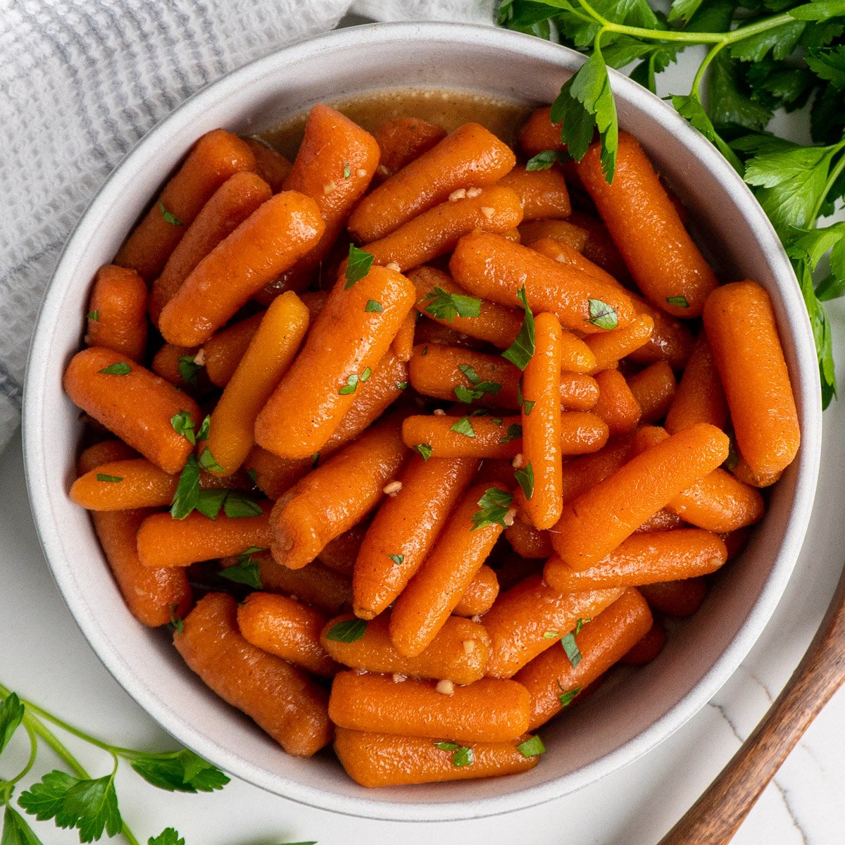 Glazed carrots in a white bowl.