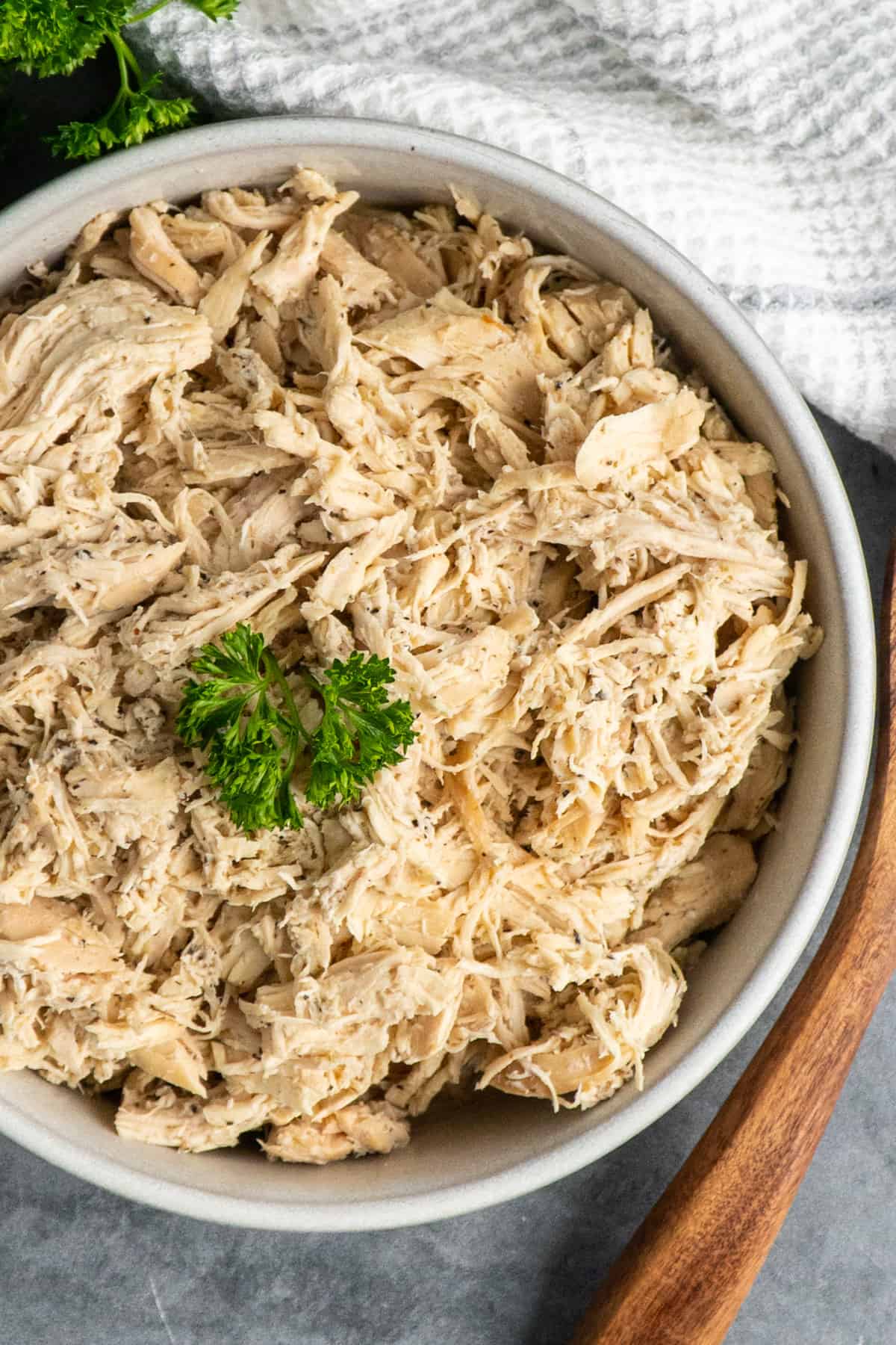 Overhead look at pulled chicken in a bowl.