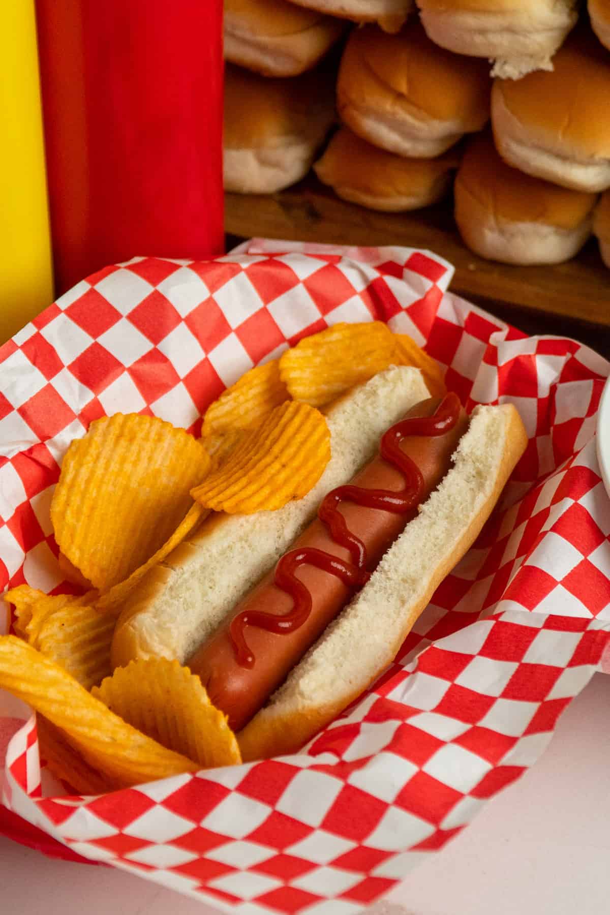 Close up of a hot dog with ketchup on it.
