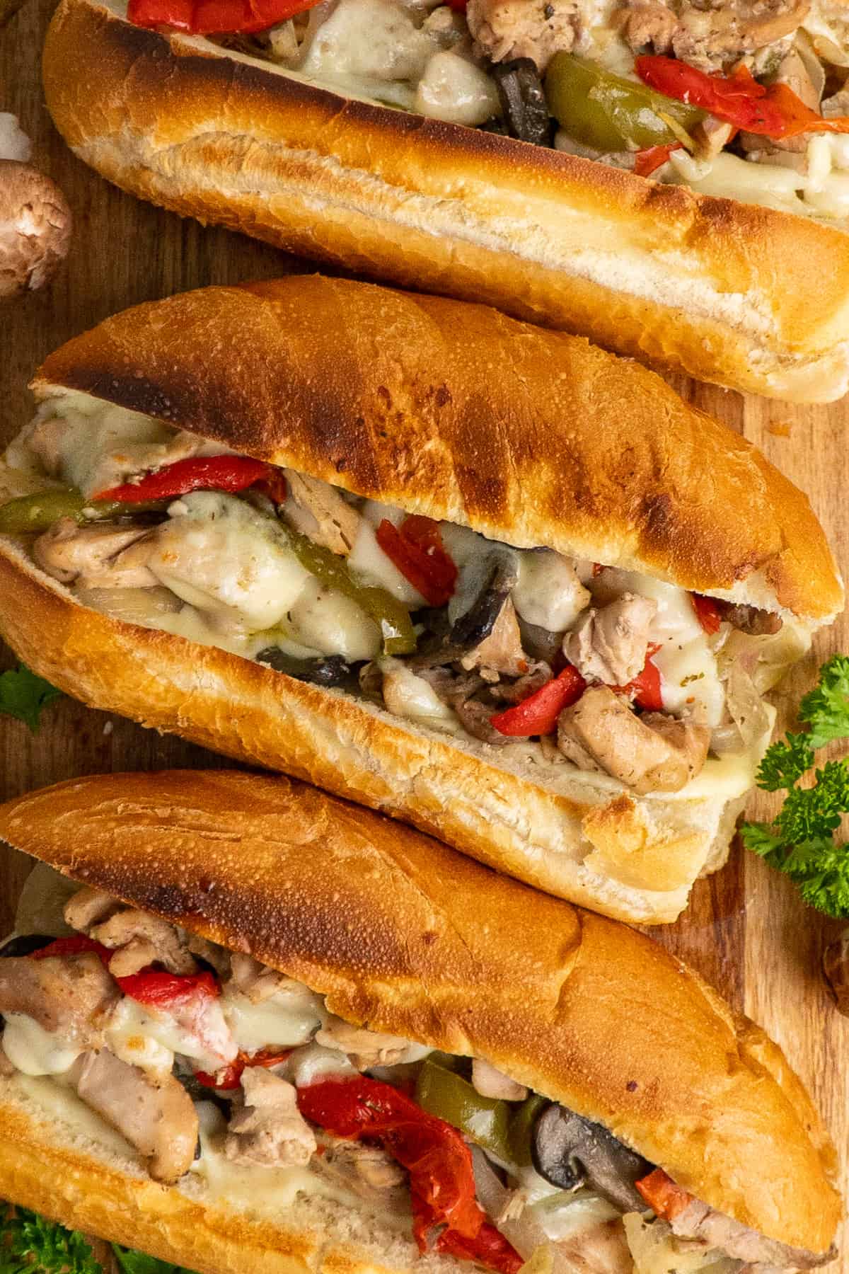 Close-up of chicken philly cheesesteak on a toasted bun.