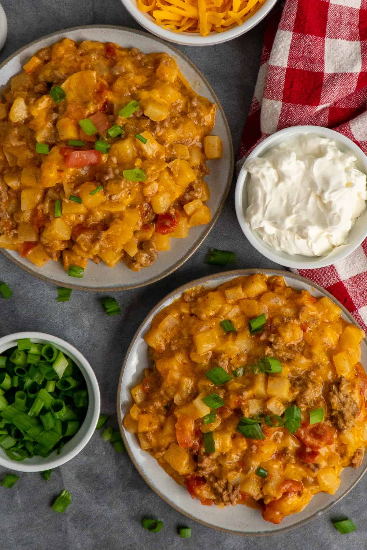 Two plates of beefy potato taco casserole.