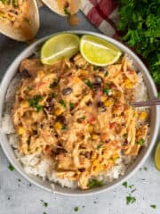 Overhead look at crock pot fiesta chicken over a bowl of rice.