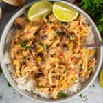 Overhead look at crock pot fiesta chicken over a bowl of rice.