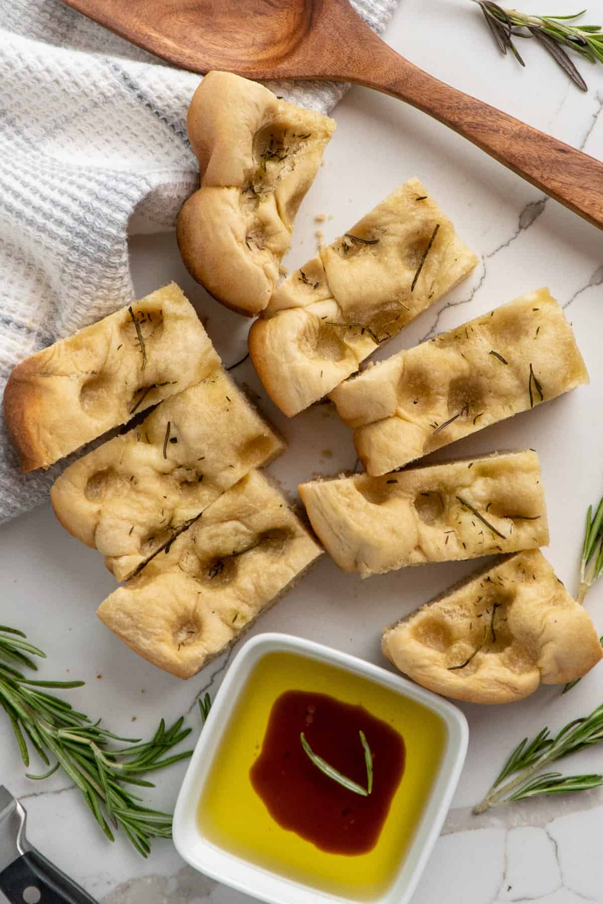 Foccacia bread cut up on a white countertop.