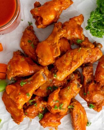 Crock Pot chicken wings on a piece of parchment paper.