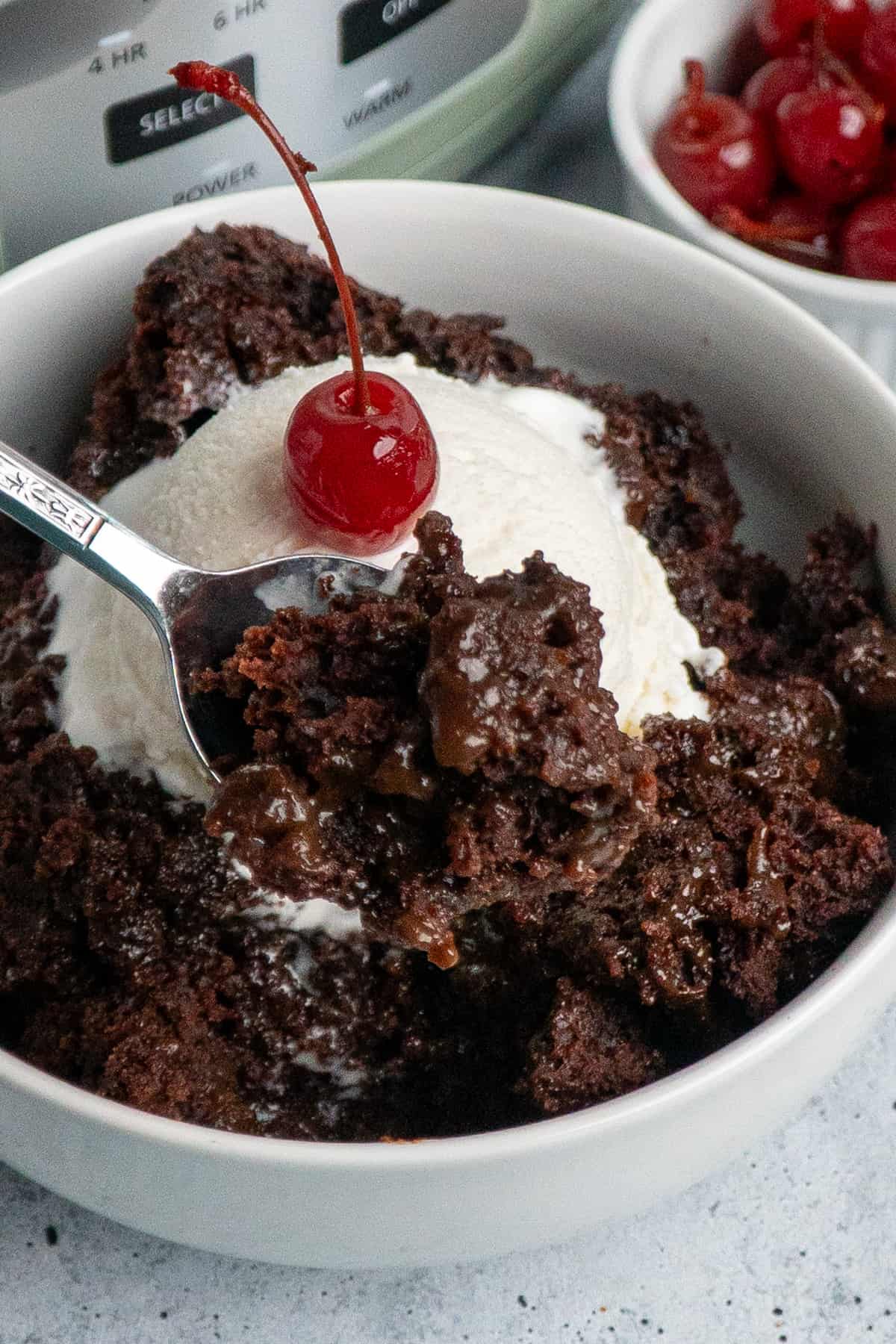 A spoon holding a bite of chocolate lava cake.