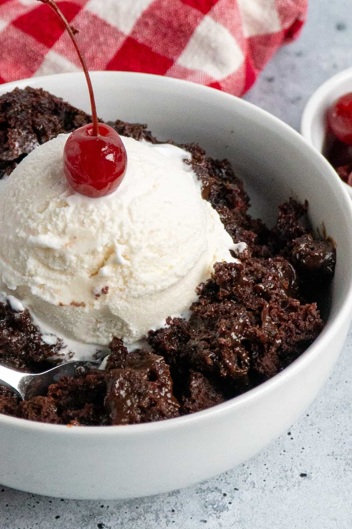 Crock pot choccolate lava cake with ice cream and a cherry on top.