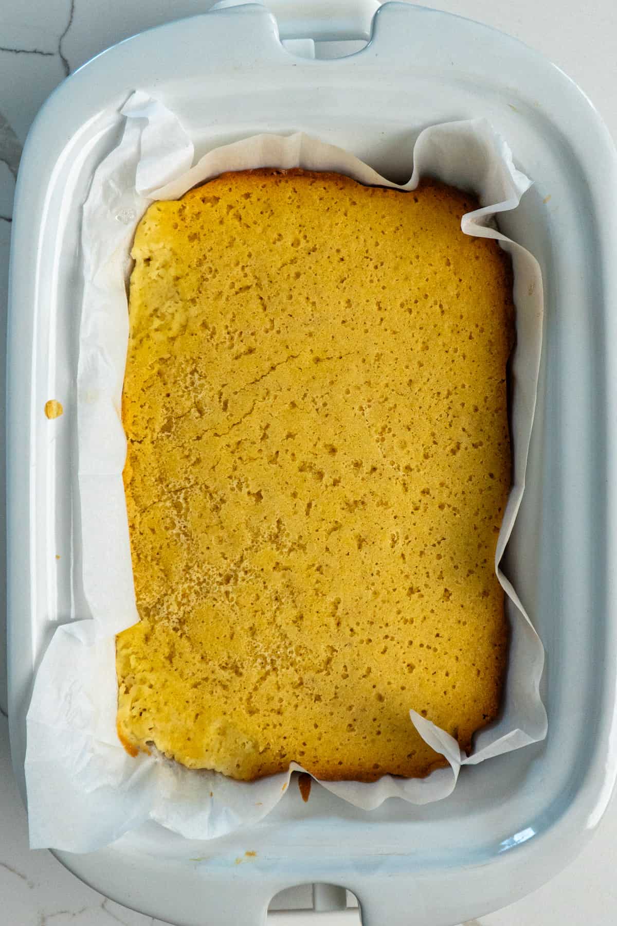 Overhead look at cornbread in a crock pot.