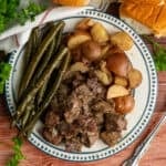 Overhead, look at steak and potatoes on a plate.