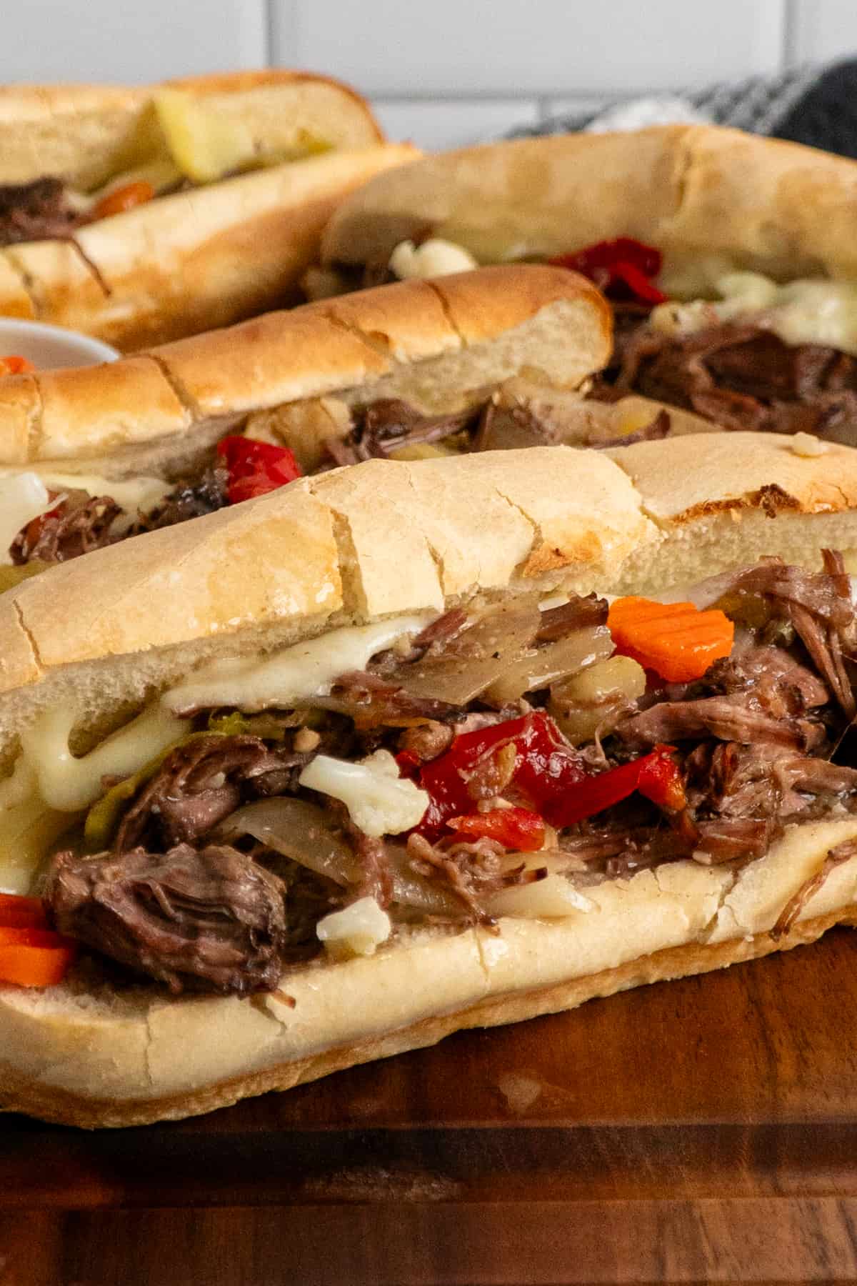 Close-up of Italian beef sandwiches on hoagie buns.
