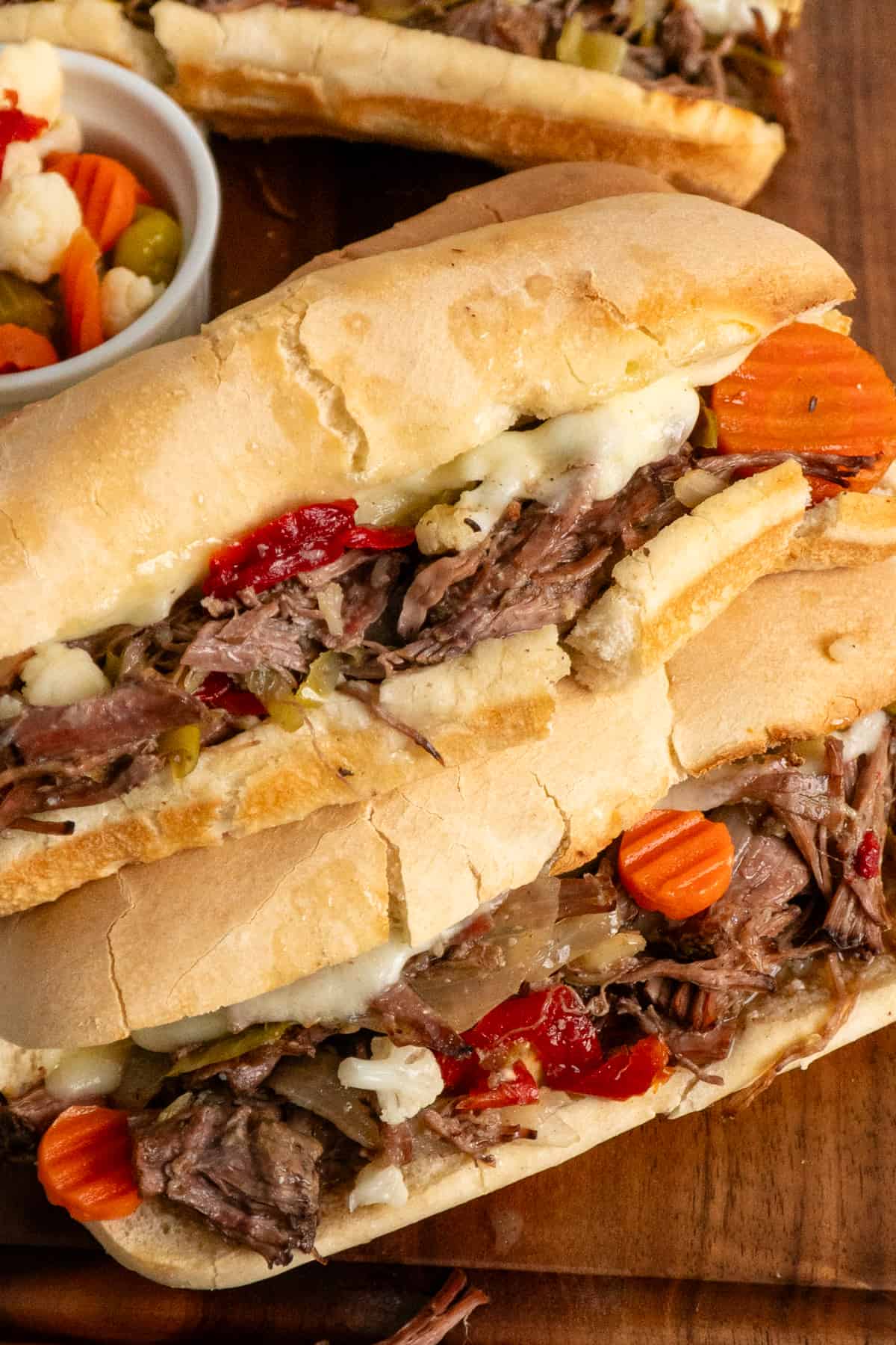 Crock pot Italian beef sandwiches stacked on top of each other.