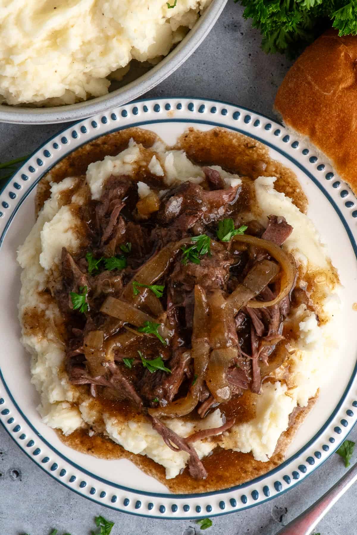 Overhead, look at French onion pot roast over mashed potatoes.