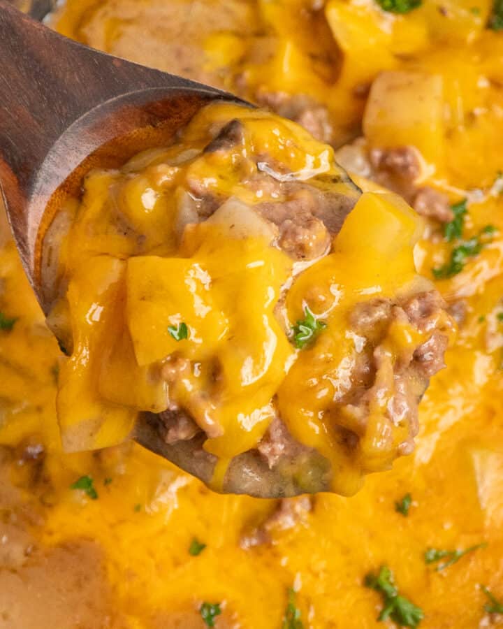 Close-up of slow cooker hamburger hash on a wooden spoon