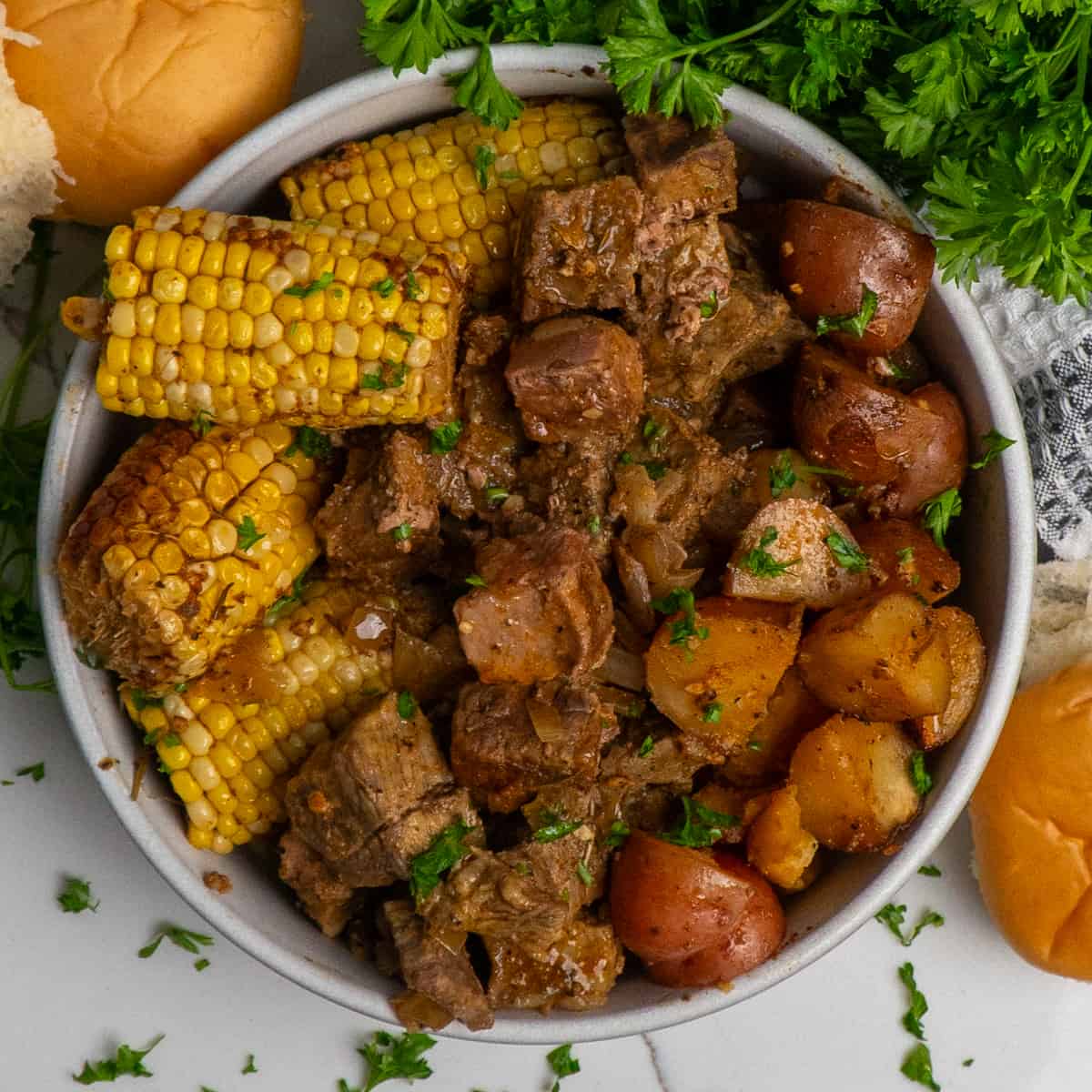 low Cooker Steak, Potatoes, and Corn  in a bowl.