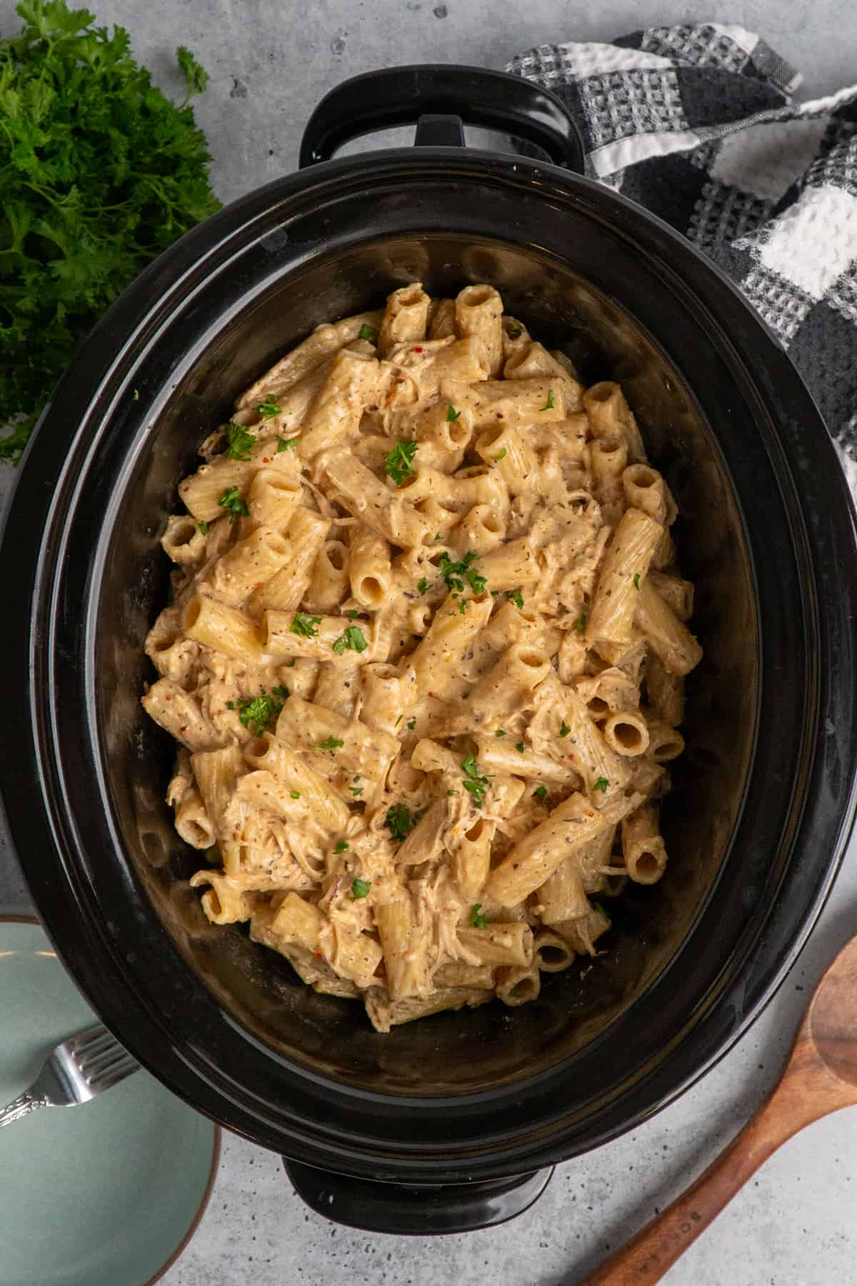 Overhead look at garlic parmesan chicken pasta in a slow cooker.