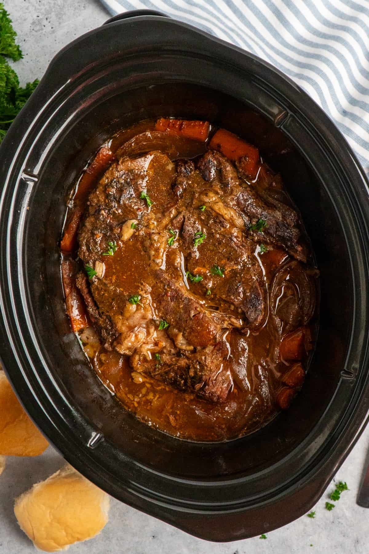 Overhead look at a pot roast in a slow cooker.