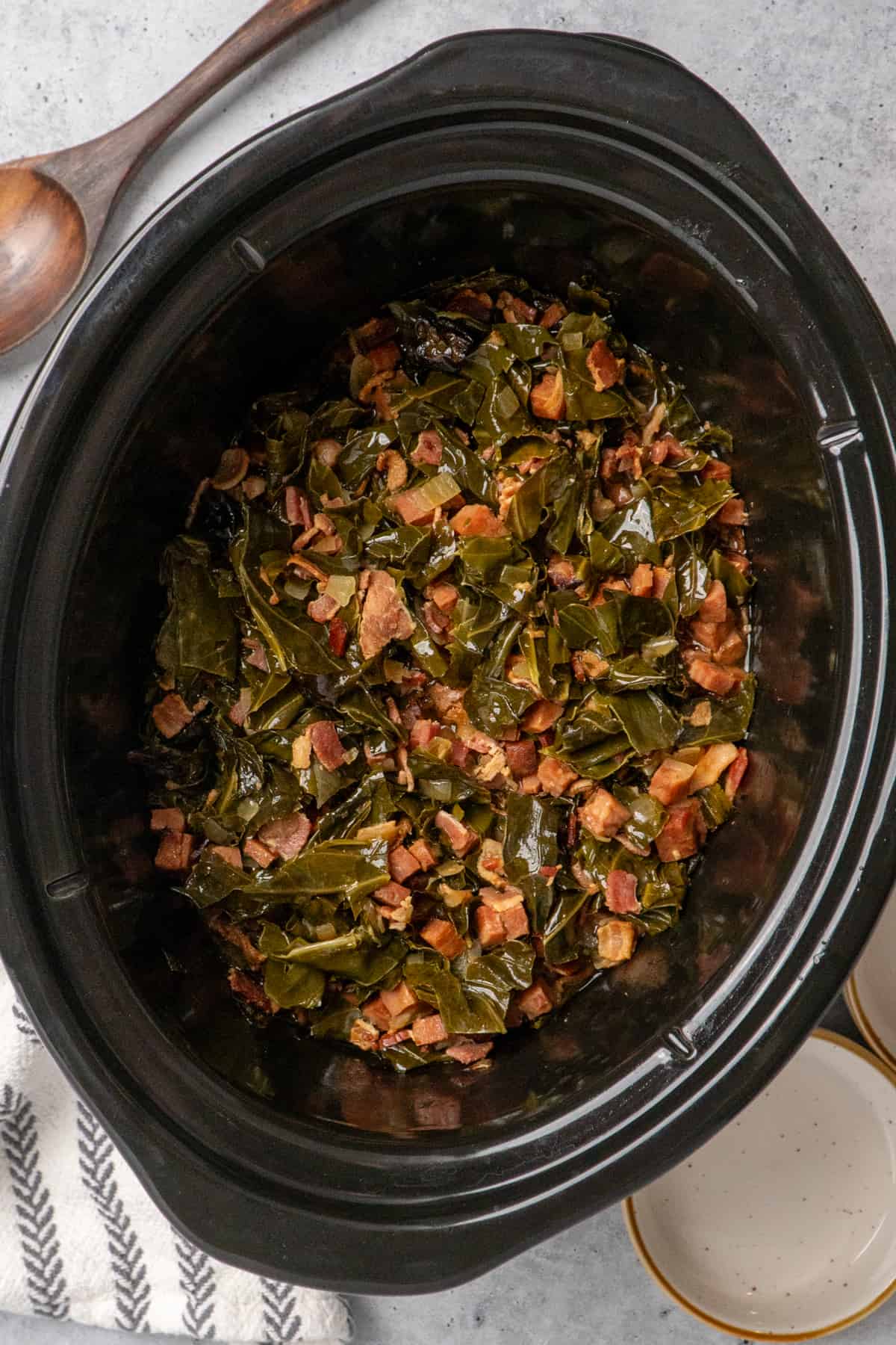 Cooked collard greens in a slow cooker.
