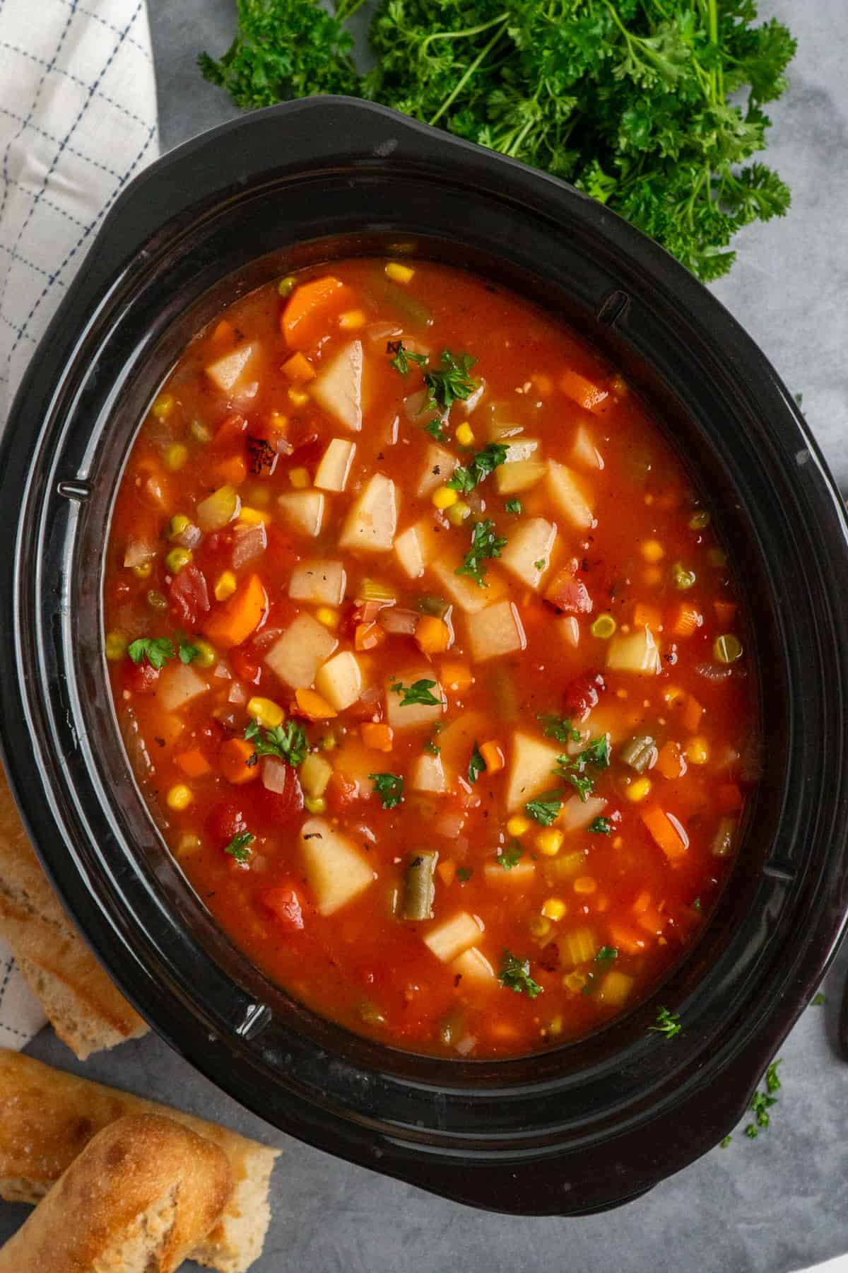 Overhead look at vegetable soup in a slow cooker.