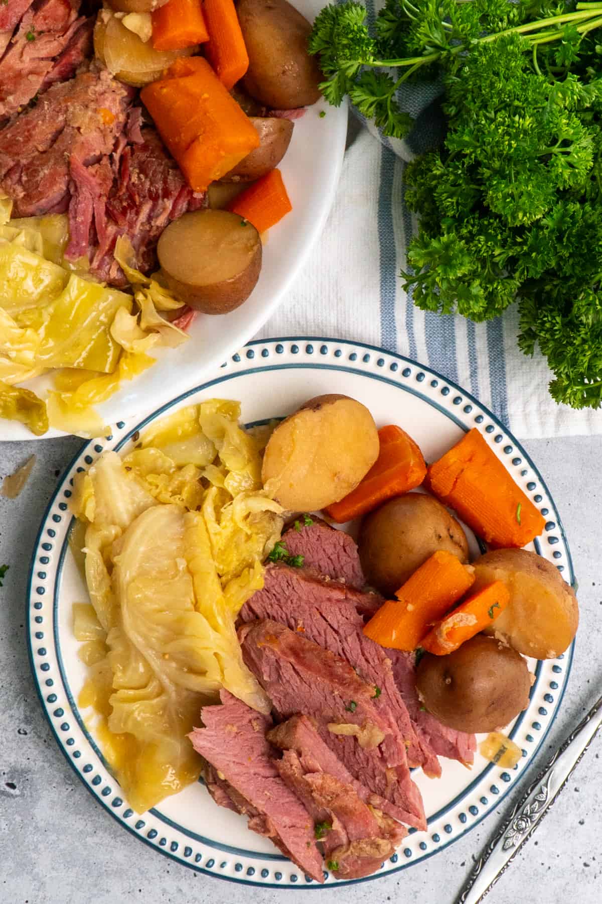 Corned beef on a platter and a plate.