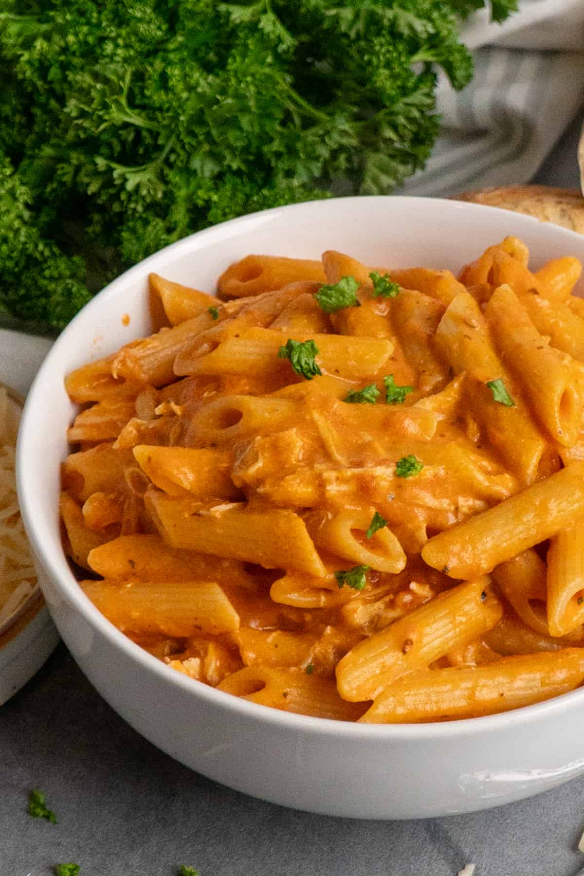 Pink sauce pasta in a white bowl.