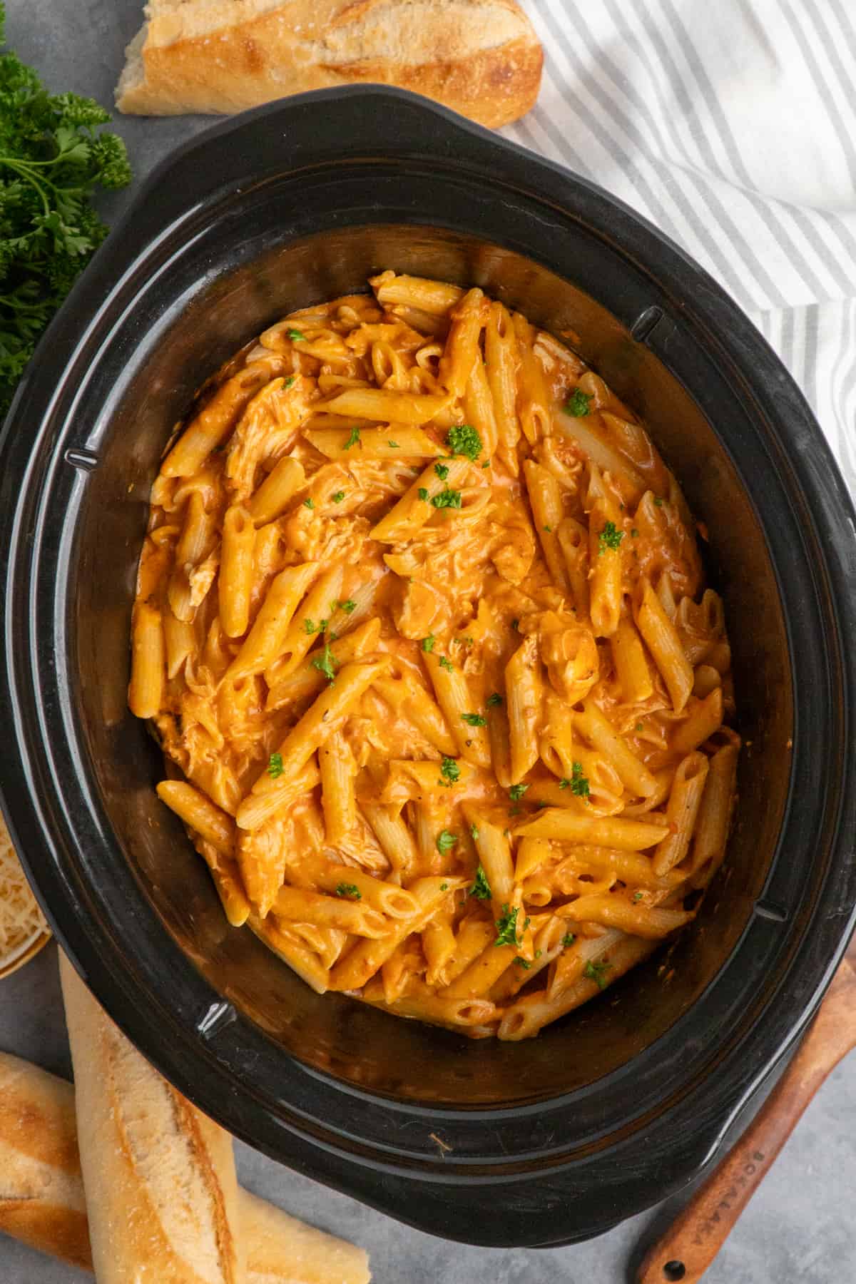 Overhead look at pink sauce pasta in a crock pot.
