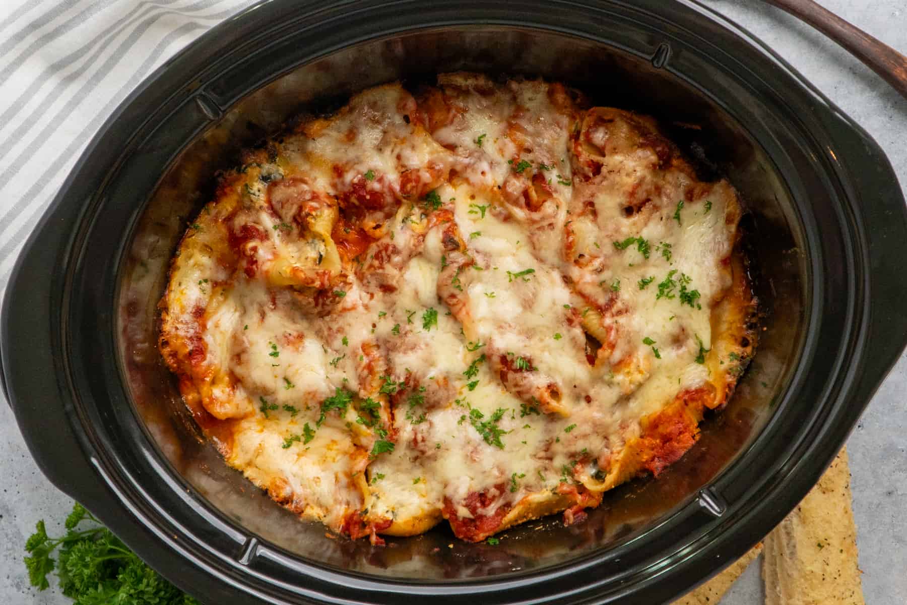 Crockpot stuffed shells cooked and garnished with parsley.